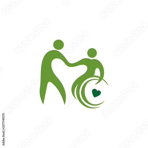 A flat, minimalist vector logo featuring green silhouettes of two figures—one standing helper and one person in a wheelchair with a dark green heart symbol inside the wheel. The design conveys themes 