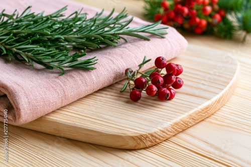 Elegant Minimal Textile Composition Featuring Blush Linen and Fresh Green Rosemary on Wood Surface