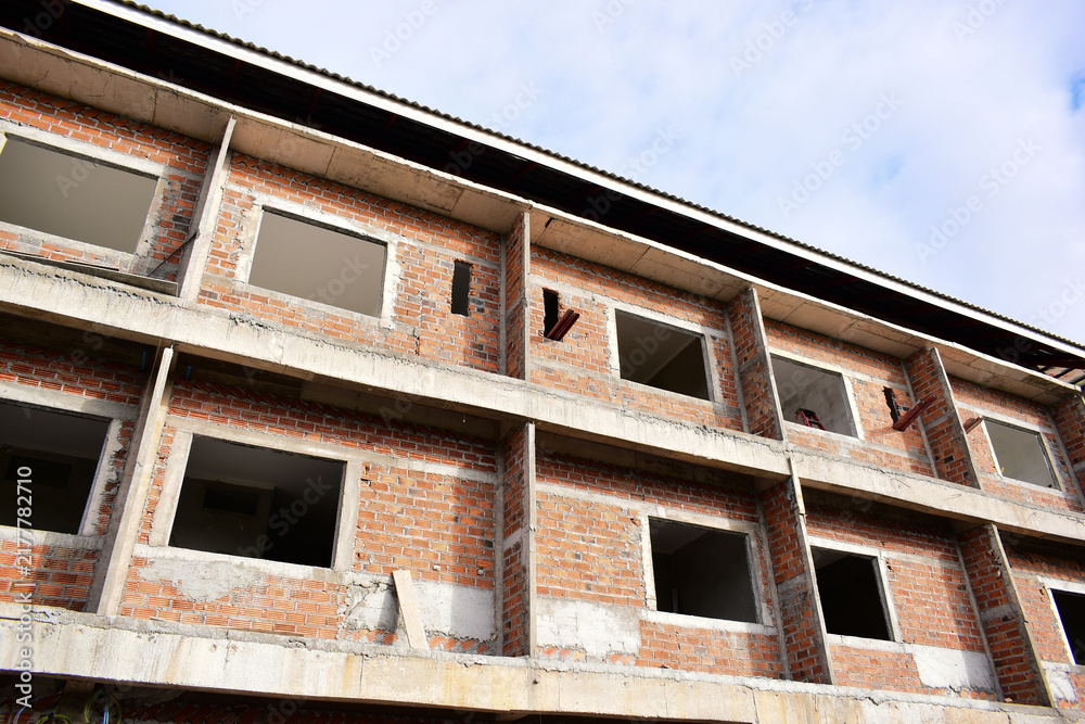 Obraz premium exterior view of brick house under construction with concrete structure