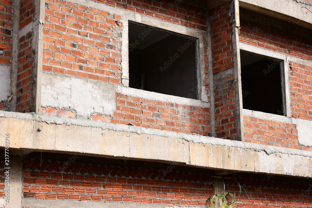 Obraz premium exterior view of brick house under construction with concrete structure