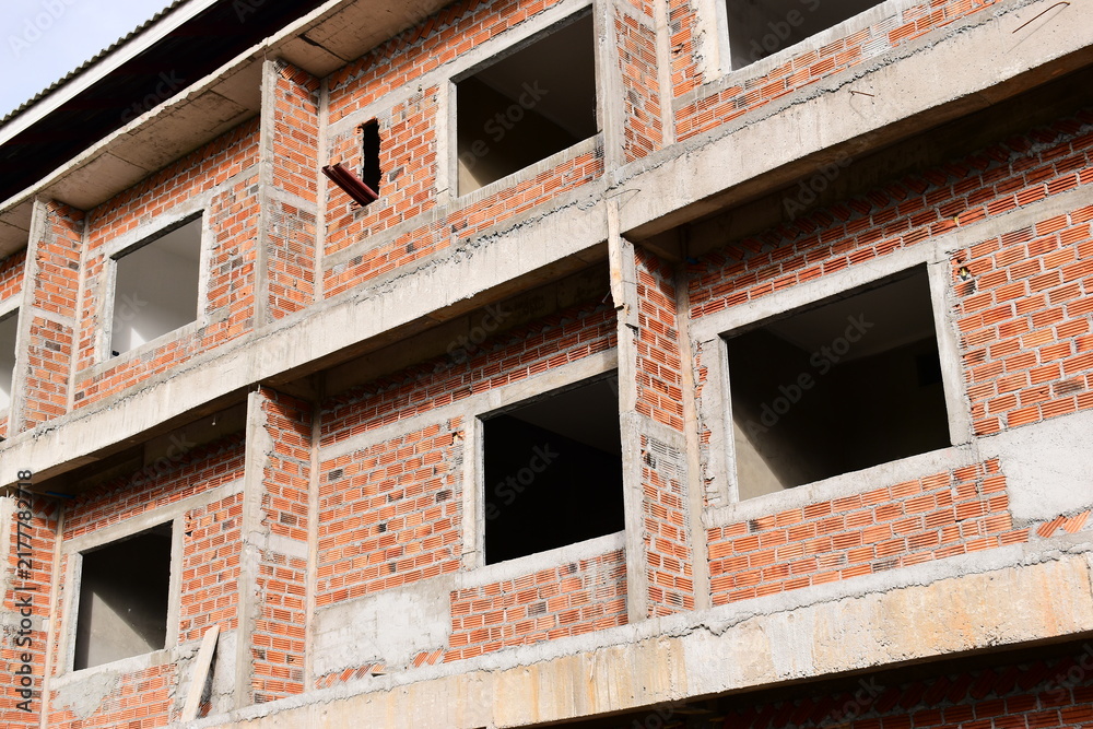 Obraz premium exterior view of brick house under construction with concrete structure