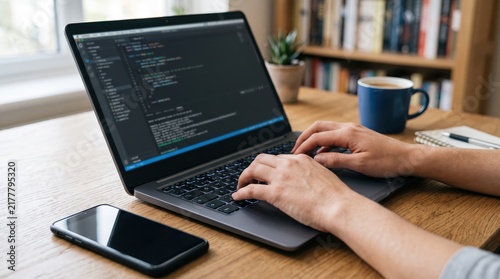 Close up of male hands typing code on laptop keyboard in home office, software developer working on programming project, dark mode editor screen, technology and coding
