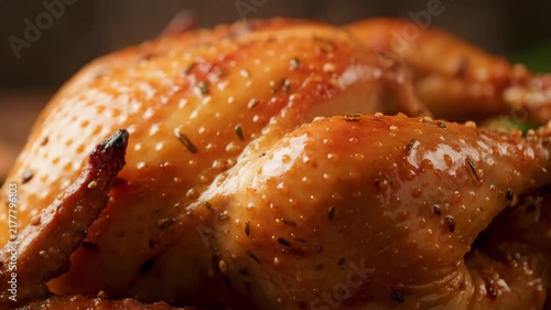 Close-up of Delicious Golden Brown Roasted Whole Chicken Skin Glazed with Herbs and Spices, Emphasizing Crispy Texture and Appetizing Meal Preparation