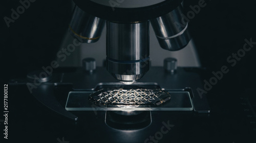 Critical minerals sourcing in microscope study, lab research on metal sample