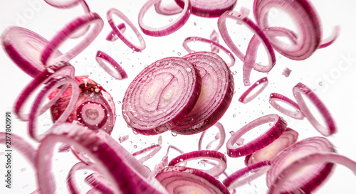 red onion slices levitating and flying through the air
