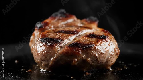 Extreme Close-up of Juicy Grilled Steak Searing on Hot Black Surface with Steam Rising, Perfect for Professional Cooking, Restaurant Menus, and Gourmet Food Concepts