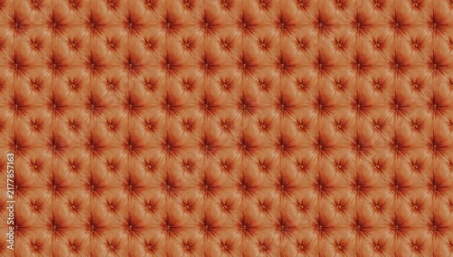 Close up of a textured orange surface with a repeating pattern of dimples