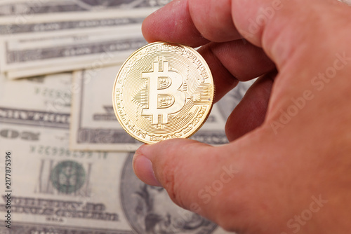 Konstfotografi Hand holding shiny golden Bitcoin coins reflecting light