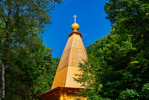 Canvas Print Traditional wooden Russian Orthodox chapel with a golden onion dome and cross, r