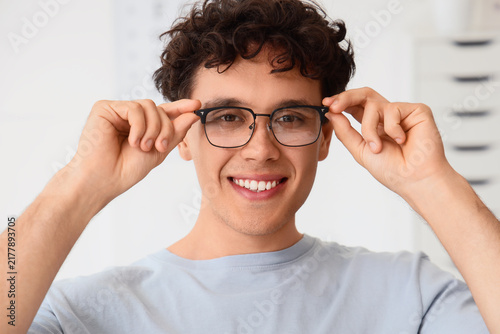 Vision care and eye health, young man wearing new prescription glasses for cl...