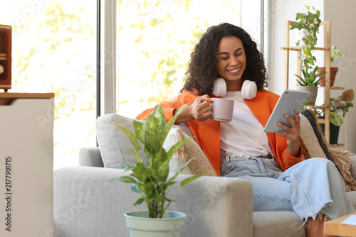 Female African-American interior designer working with tablet computer and co...