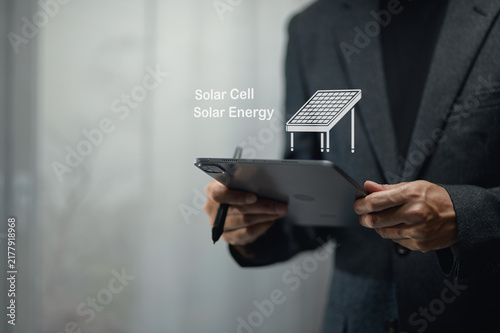 Businessman Using Tablet with Virtual Solar Cell Illustration for Renewable Power Concept