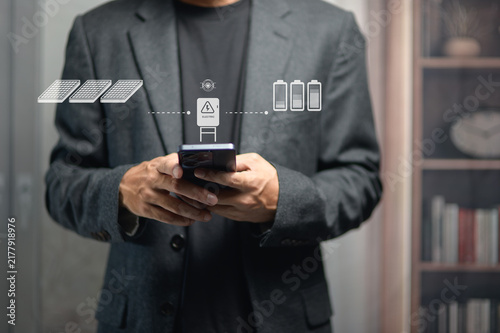 Business Professional Using Smartphone with Digital and Battery Icons Overlay