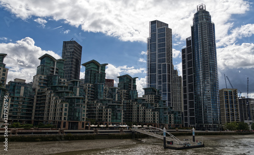 Contemporary residential architecture featuring curved glass balconies and modern design along the River Thames waterfront in London, England.
