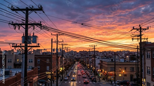 Urban Streetscape at Sunset with Power Lines and City Lights