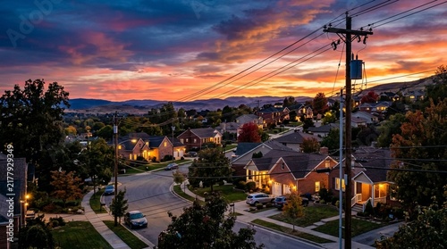 Suburban neighborhood at sunset with colorful sky and homes