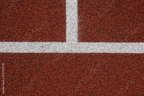 Naklejka Running track surface texture with white line.