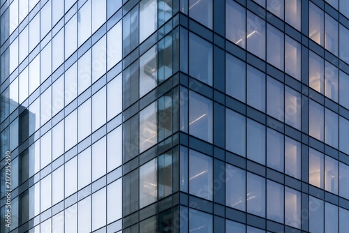 Office tower corner with illuminated interior and glass grid