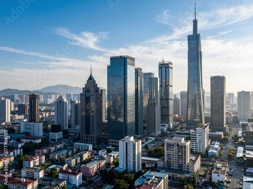 Aerial view of modern skyscrapers in a city center district under a bl