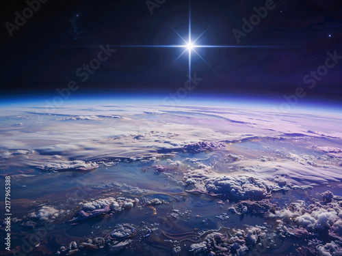Aerial view of purple planet atmosphere and cloud layers with a bright