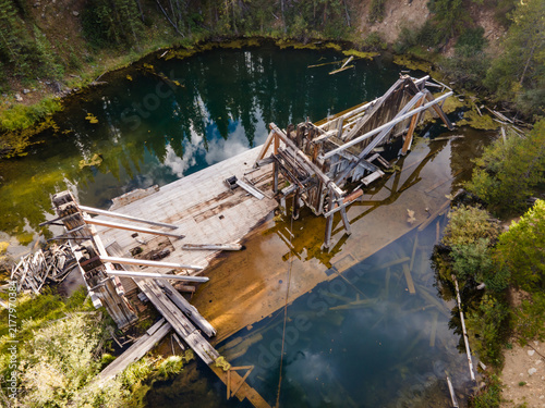 Crumbling dredge in a crystal clear lake