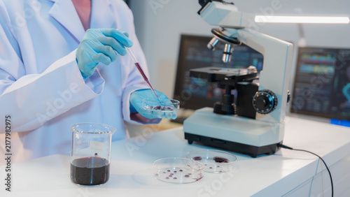 Canvastavla Scientist using digital tablet and stylus next to microscope in modern medical l