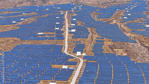 Принти на полотні Aerial view of large solar power station on dry hillside terrain