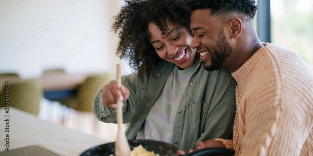 Obraz premium Happy couple cooking together at home kitchen for lifestyle social media banner and cozy background