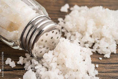 Obraz na płótnie Sodium chloride sea salt with salt shaker.