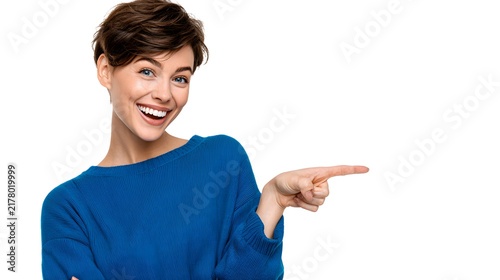 A person smiling and pointing sideways, isolated on white background.