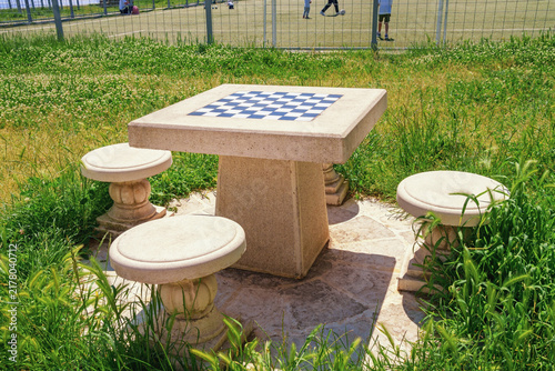 Сhess table in park near football field on sunny summer day. Montenegro, Tivat
