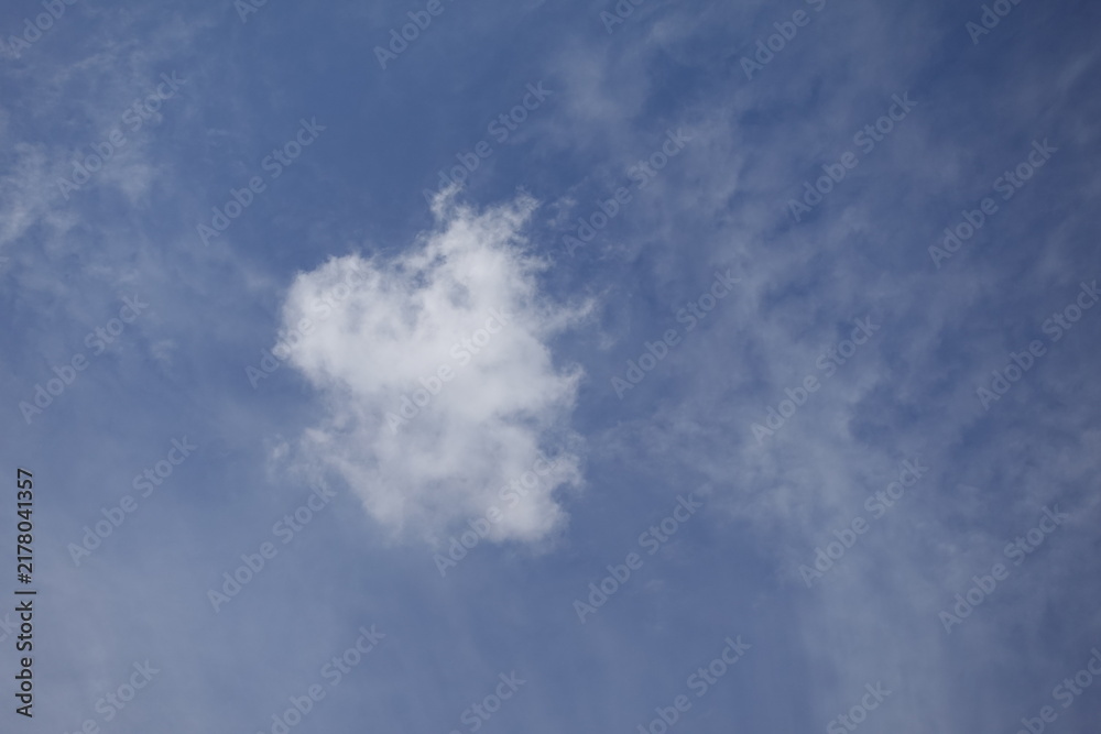 Fototapeta premium Soft white cloud floating alone in a clear blue sky