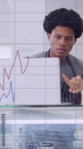Animation of data processing over diverse waiter and waitress discussing over a laptop at a cafe