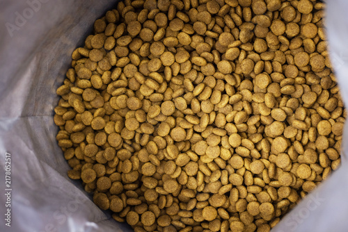 Open bag of dry kibble in a pet food store. Kibble, dry food, animal feed, shop, detail