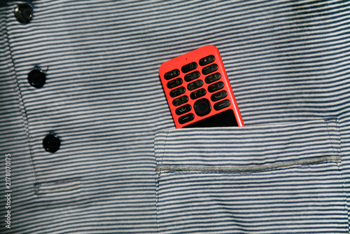 Photography Close up of dumb phone on the shirt pocket