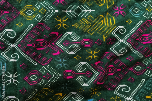 Fotografie Vibrant tribal patterns adorn dark green fabric