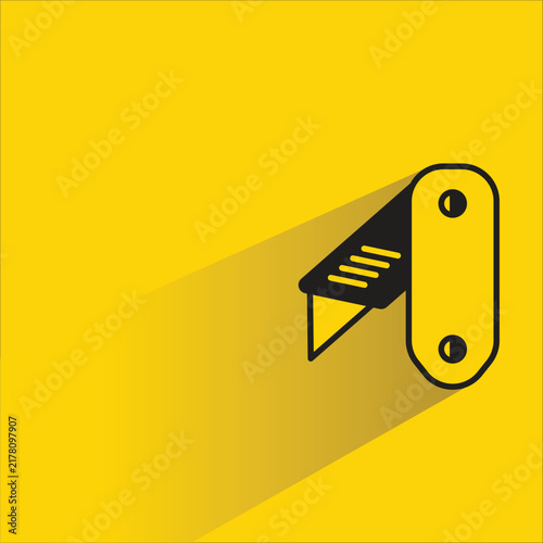 фотографія penknife icon with shadow on yellow background