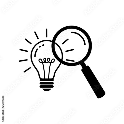 Magnifying glass examining a glowing light bulb icon