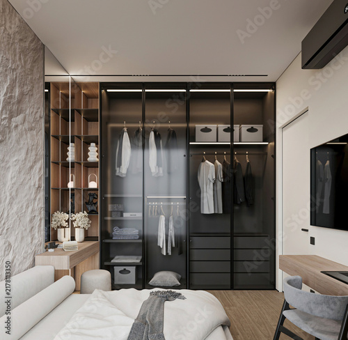 Фотография Modern luxury bedroom with open glass wardrobe, upholstered bed, textured stone wall, built-in shelving and warm wood details in a sophisticated apartment interior