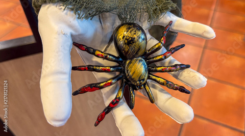 halloween spider prop held by hand, spooky decoration, banner ready, concept of halloween store, party