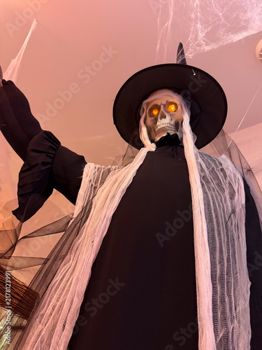 Halloween witch skeleton with glowing eyes, spooky hanging decoration
