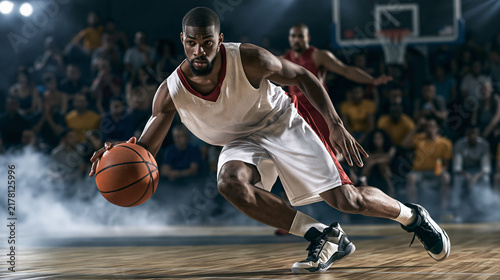 Basketball Player Dribbling A determined basketball player in action, dribbling the ball intensely on a smoky court with an intense crowd in the background, highlighting the dynamism of the game.