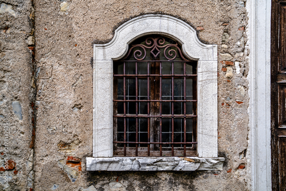Obraz premium Arched Window with Decorative Iron Grille