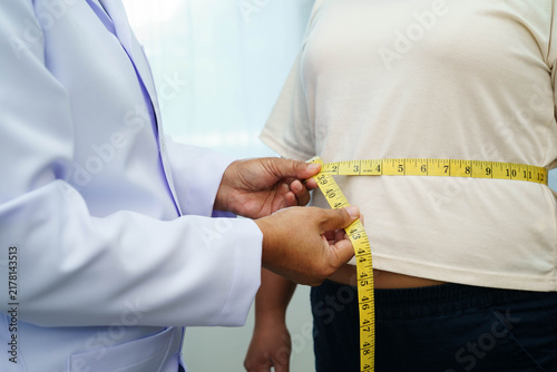Foto Asian woman with fat belly big size overweight and obesity with measure tape