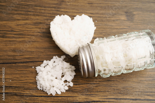 Obraz na płótnie Sodium chloride sea salt with salt shaker.