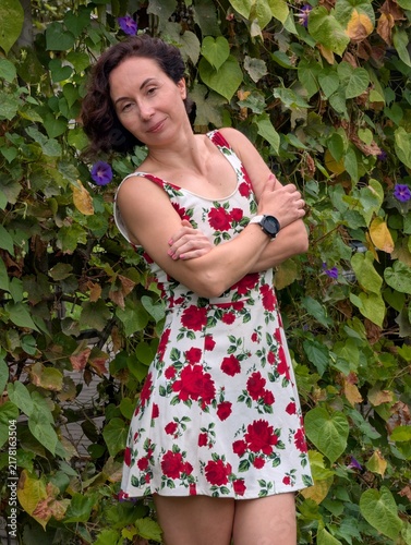 Woman in Floral Dress Posing in Garden