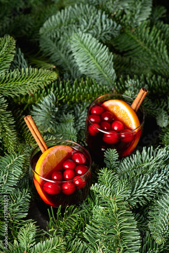 Fotografía Mulled wine with orange, cranberry and cinnamon in fir forest setting