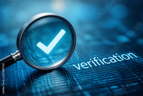 A magnifying glass with a checkmark over digital code representing verification in a blue, tech-themed setting.
