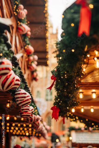 Christmas decorations on houses at the Christmas market in Wroclaw, Poland. View of garlands, ornaments and fir branches