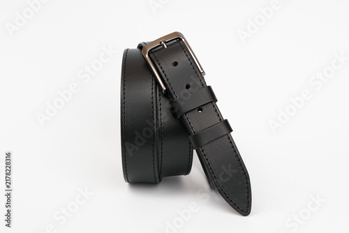Black smooth leather men's belt with stitching and metal buckle isolated on white background